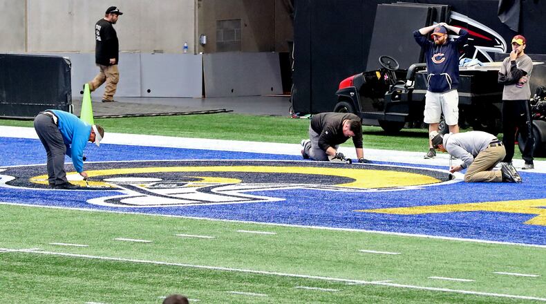 Workers painted the Los Angeles Rams logo in one end zone at Mercedes-Benz Stadium in preparation for the Super Bowl.