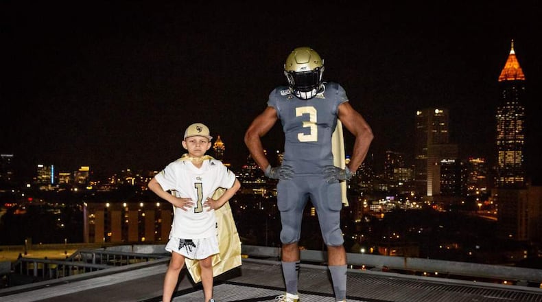 The Georgia Tech alternate uniform that the Yellow Jackets will wear October 5 for a home game against North Carolina, as worn by a model. The uniforms will pay homage to patients at Children's Healthcare of Atlanta as part of the hospital's "Cape Day" festivities. The boy in the photo is an actual CHOA patient and diehard Jackets fan.