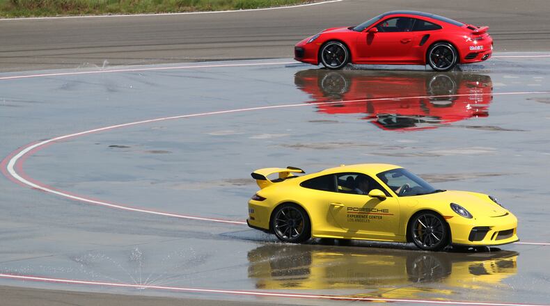 Drivers negotiate the Low-Friction Circle at the Porsche Experience Center Los Angeles on April 10, 2018. This course allows drivers to experience under and oversteer. The 53-acre facility is open to the public even if you don't own a Porsche. (Myung J. Chun/Los Angeles Times/TNS)
