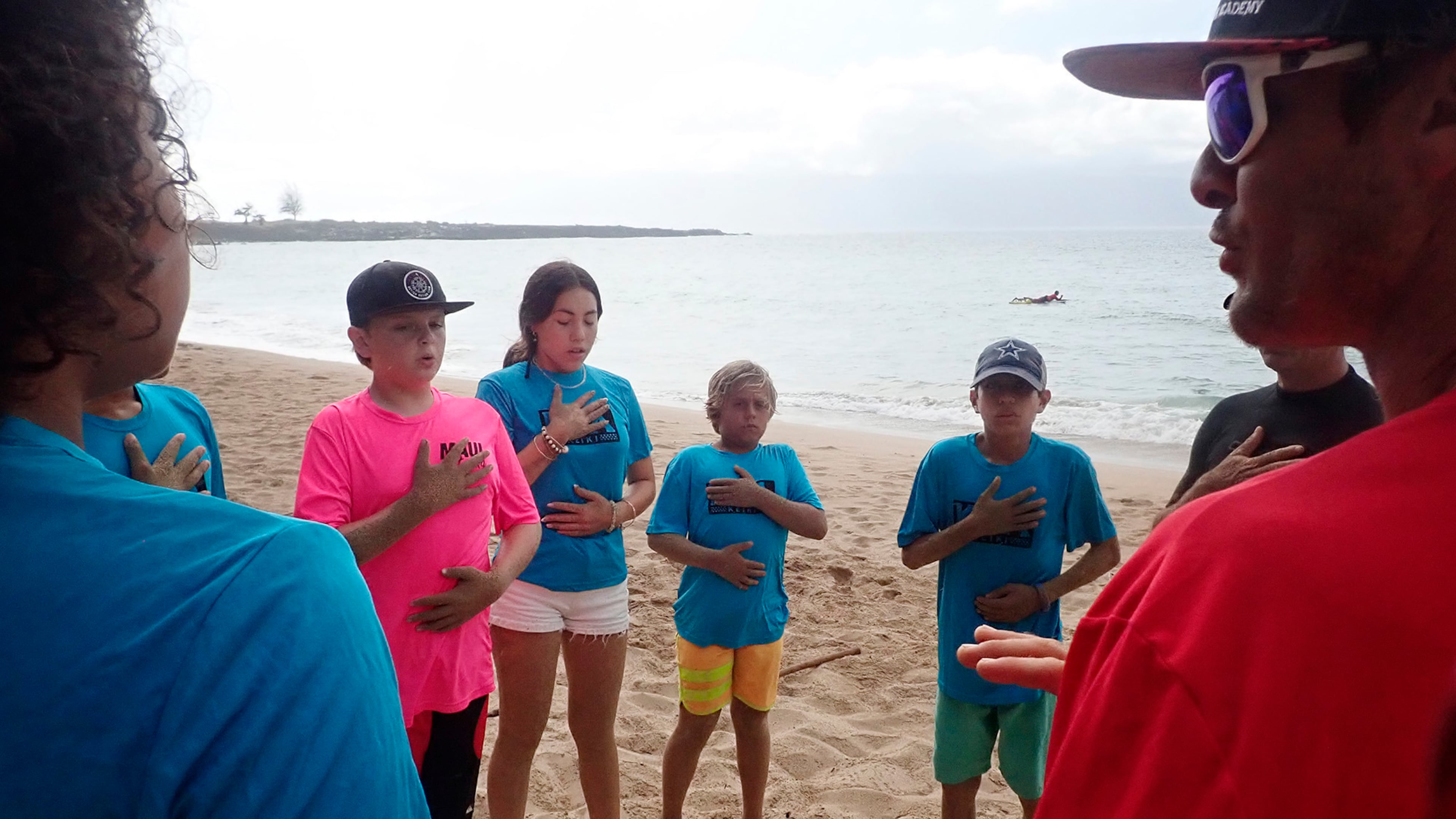 Maui Hero Project's Joseph Anderson, DayJahiah Valdivia, Ocean Viera and Ivan Macias follow Kahākūahi Ocean Academy's Zane Kekoa Schweitzer's breathing exercise to re-center themselves after the beach physical training and lifeguard skills training in Lahaina, Hawaii, on Tuesday, June 10, 2025. Anderson and Valdivia were affected by the August 2023, fires on Maui. (Kevin Fujii/Honolulu Civil Beat via AP)