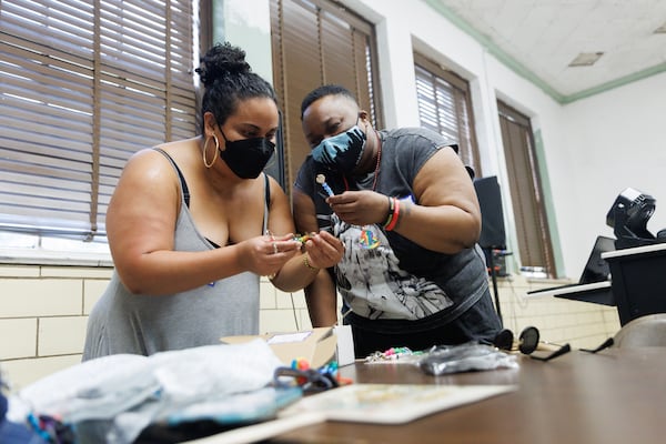 Patrons search through handmade charms during the Southern Fried Queer Pride Spaghetti Dinner and Bingo event. Rather than replacing gay bars, organizations are expanding the places where queer Atlantans can find community. (Estela Muñoz/AJC)