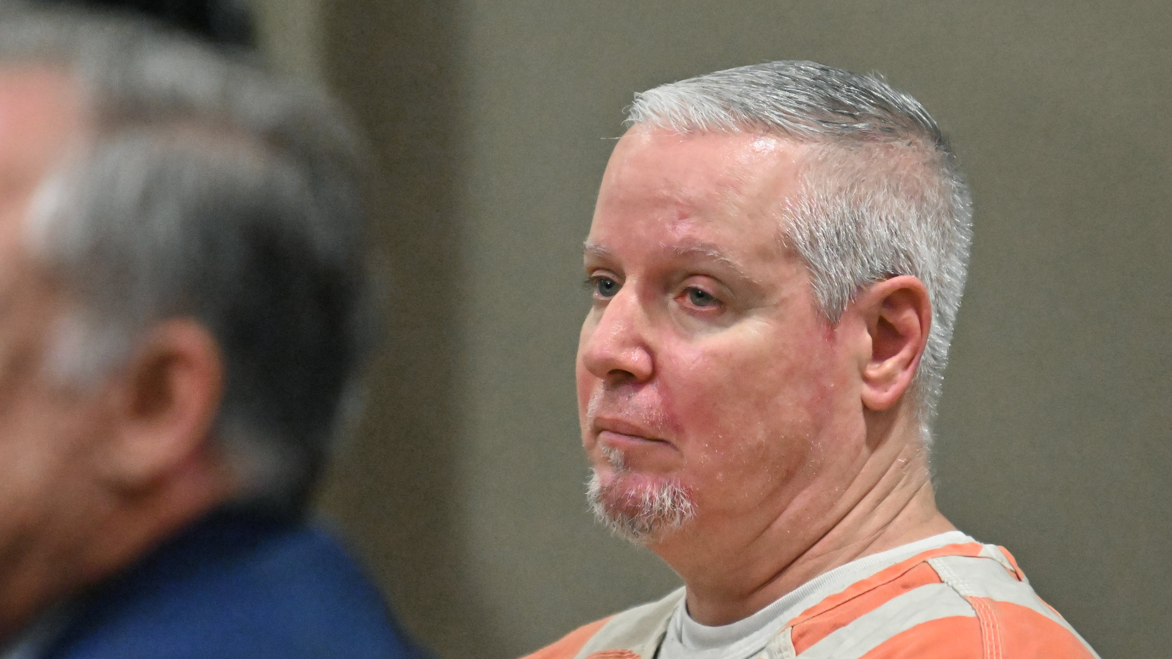 Colin Gray, the father of the Apalachee High School shooting suspect, sits with his attorneys during a July hearing at the Barrow County courthouse. A judge this week scheduled his trial for next year. (Hyosub Shin/AJC)