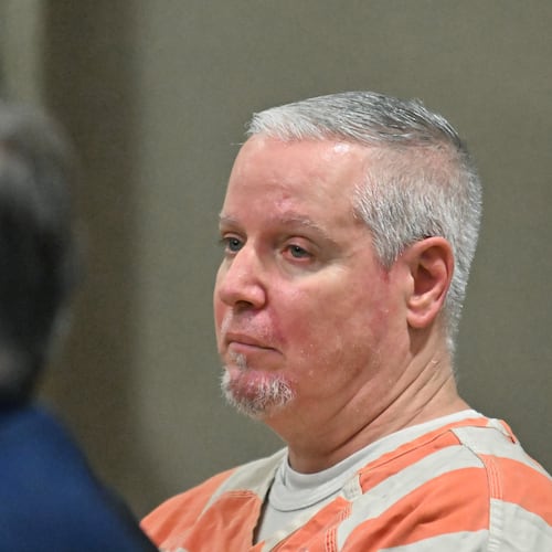 Colin Gray, the father of the Apalachee High School shooting suspect, sits with his attorneys during a July hearing at the Barrow County courthouse. A judge this week scheduled his trial for next year. (Hyosub Shin/AJC)