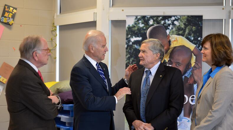 Vice President Joe Biden, second from left, talks with Sen. Sam Nunn, left, developer Tom Cousins and executive director of the East Lake Foundation, Carol Naughton at the East Lake Early Leaning Academy Tuesday March 4, 2014.