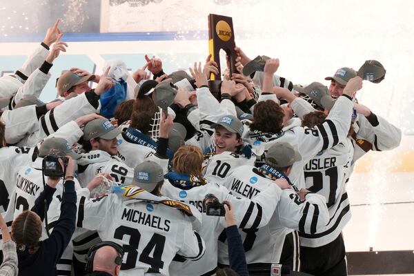 Members of Western Michigan celebrate after defeating Boston University in the championship game of the NCAA Frozen Four men's college hockey tournament, Saturday, April 12, 2025, in St. Louis (AP Photo/Jeff Roberson)