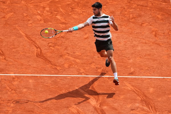 Spain's Carlos Alcaraz plays a shot against Italy's Jannik Sinner during their final match of the French Tennis Open at the Roland-Garros stadium in Paris, Sunday, June 8, 2025. (AP Photo/Lindsey Wasson)