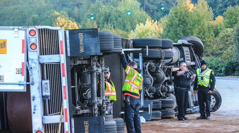 A tractor-trailer overturned on the ramp from I-285 West to Peachtree Industrial Boulevard Tuesday morning, blocking the ramp and causing some major delays through DeKalb County.