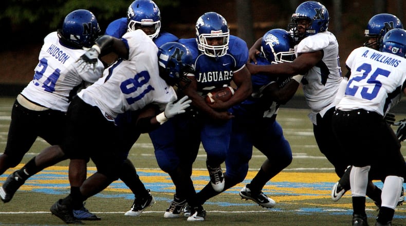 A Stephenson running back breaks through the Newton defensive line during the Jaguars' 22-16 win over the Rams.
