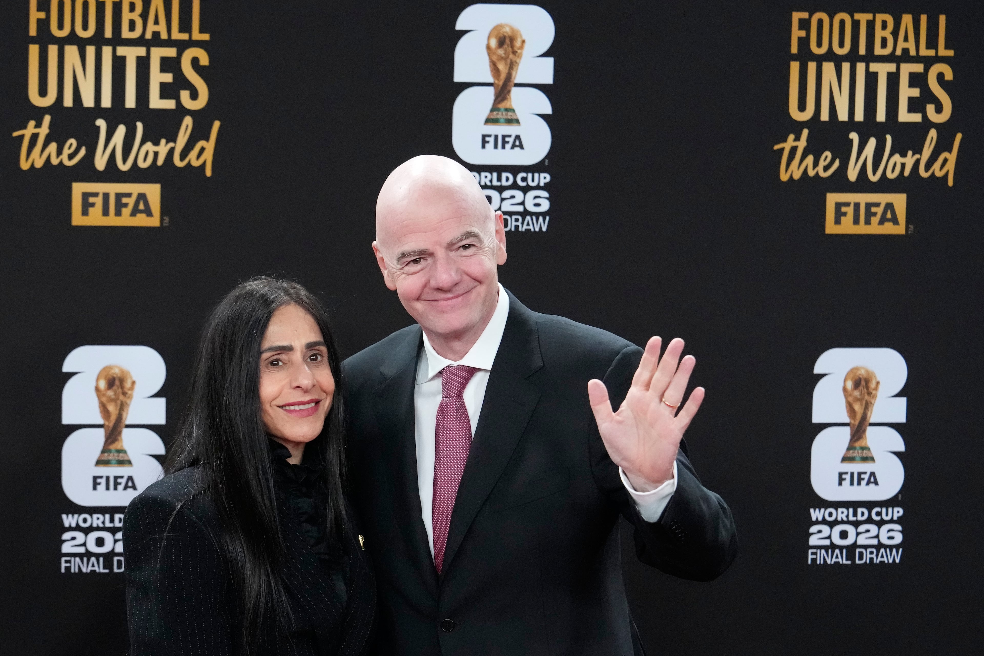 FIFA President Gianni Infantino and his wife Leena Al Ashqar pose for a photo as they arrive for a welcome reception ahead of the draw for 2026 soccer World Cup at the Kennedy Center in Washington, Thursday, Dec. 4, 2025. (AP Photo/Chris Carlson)