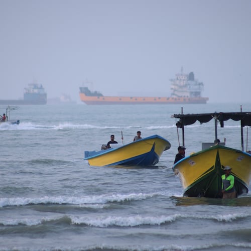Small boats line the shore as cargo ships and other commercial vessels appear anchored in the Strait of Hormuz off Bandar Abbas, Iran, Monday, July 27, 2026. (Razieh Poudat/ISNA via AP)