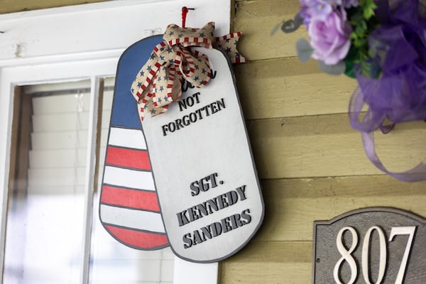 A tribute to Army Reserve Sgt. Kennedy L. Sanders hangs from her parents' home in Waycross on May 16, 2025. (Arvin Temkar/AJC)