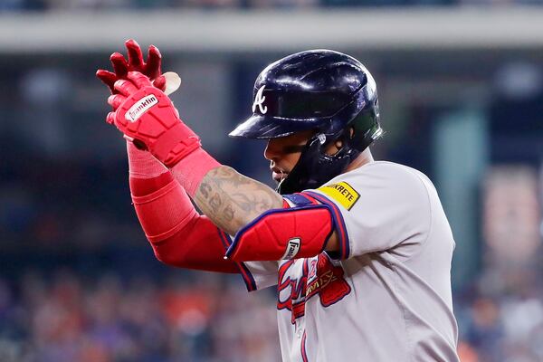 Braves shortstop Orlando Arcia celebrates his 10th-inning RBI single.
