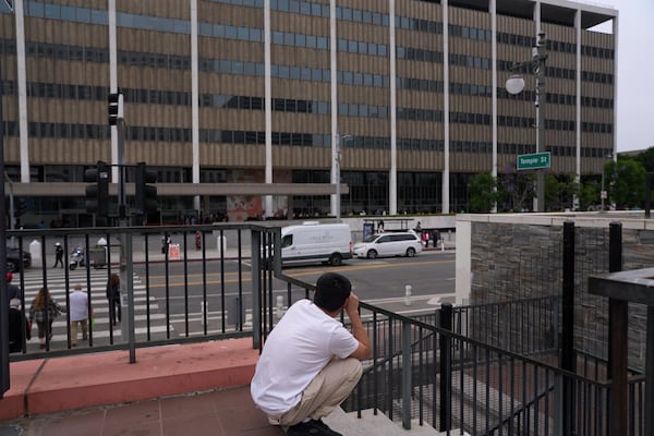 People line up outside the Los Angeles Federal Building in Los Angeles, housing the U.S. Immigration and Customs Enforcement (ICE) and U.S. Citizenship and Immigration Services (USCIS) on Wednesday, June 25, 2025. (AP Photo/Damian Dovarganes)