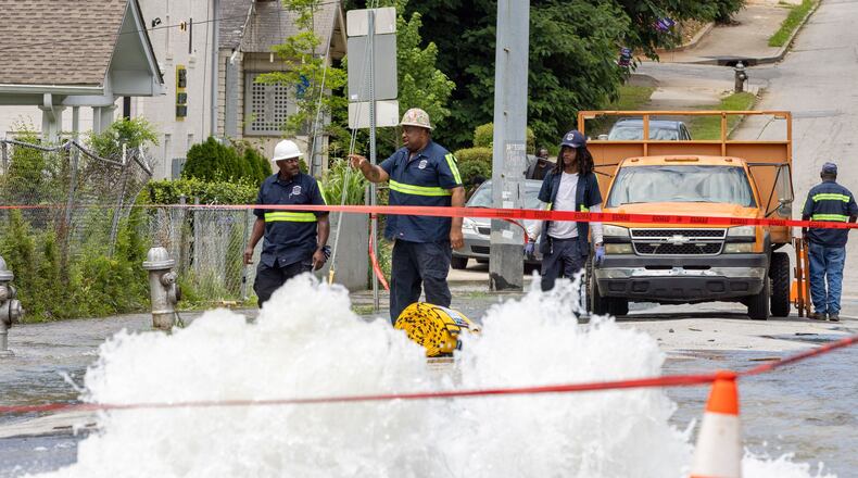 Workers take care of a water main break at Joseph E. Boone Boulevard and James P. Brawley Drive in Atlanta on Friday, May 31, 2024. (Arvin Temkar/The Atlanta Journal-Constitution/TNS)