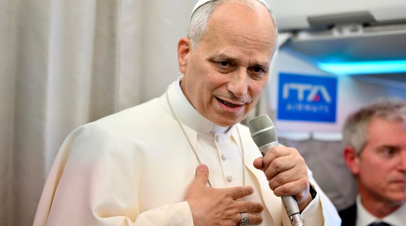 Pope Leo XIV talks to reporters aboard an airplane as he returns from a six-day visit to Turkey and Lebanon, Tuesday, Dec. 2, 2025. (Alessandro Di Meo/Pool Photo via AP)