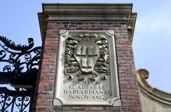 FILE - A relief sculpture rests on a gate to the entrance of Harvard University, in Cambridge, Mass., March 13, 2016. (AP Photo/Steven Senne, File)