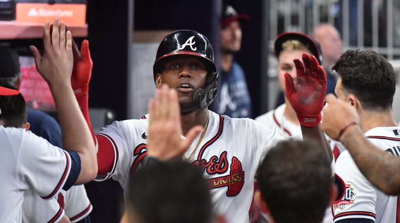 Braves Jorge Soler celebrates in the dugout after his home run in Thursday's Braves-Phillies game at Truist Park that clinched the NL East. (Hyosub Shin/hshin@ajc.com)