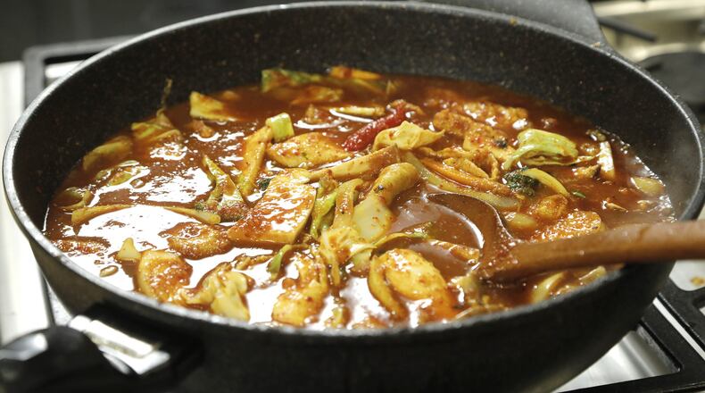 Jai Nam “Mommy Choi” Choi, makes a traditional spicy Korean rice cake dish — dduk-bok-gi — usually made during the holidays. (Myung J. Chun/Los Angeles Times/TNS)