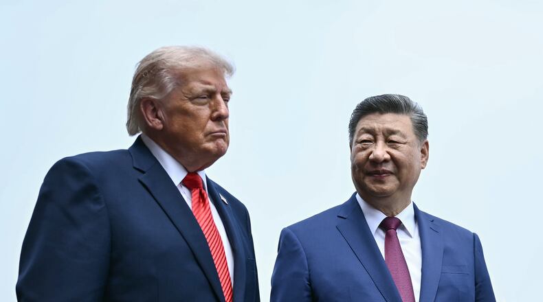 FILE - China's President Xi Jinping, right, and U.S. President Donald Trump visit the Temple of Heaven in Beijing, May 14, 2026. (Brendan Smialowski/Pool Photo via AP, File)