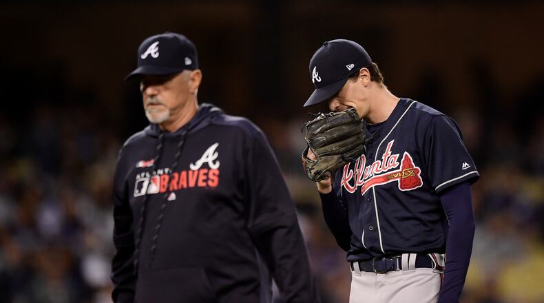 Braves starting pitcher Max Fried, right, is led off the field after being hit by a batted ball during the second inning of a baseball game against the Los Angeles Dodgers, Tuesday, May 7, 2019, in Los Angeles. (AP Photo/Mark J. Terrill)
