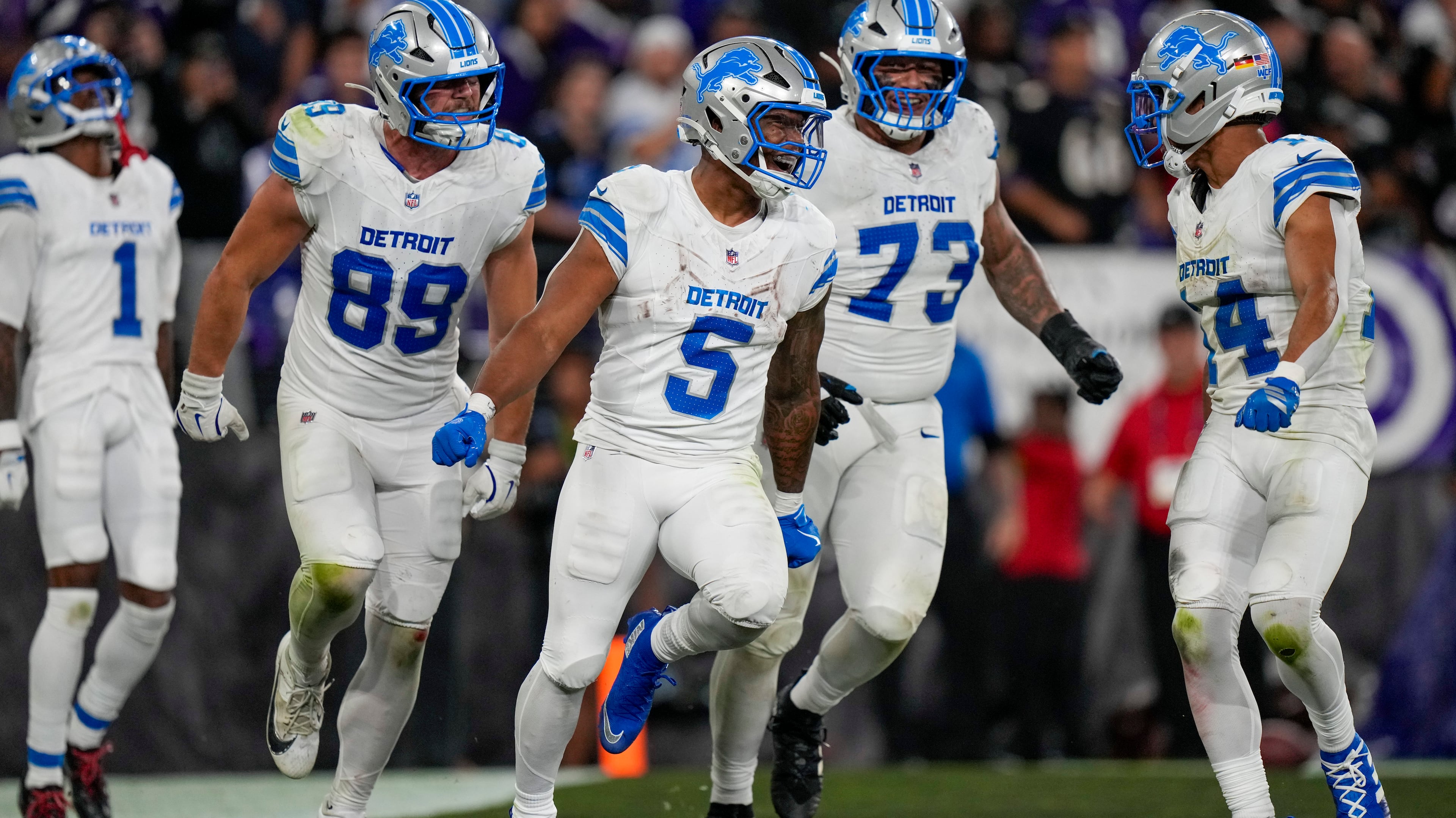 Detroit Lions running back David Montgomery (5) celebrates his touchdown run with teammates wide receiver Jameson Williams (1), tight end Brock Wright (89), guard Christian Mahogany (73) and wide receiver Amon-Ra St. Brown (14) during the second half of an NFL football game against the Baltimore Ravens Monday, Sept. 22, 2025, in Baltimore. (AP Photo/Stephanie Scarbrough)