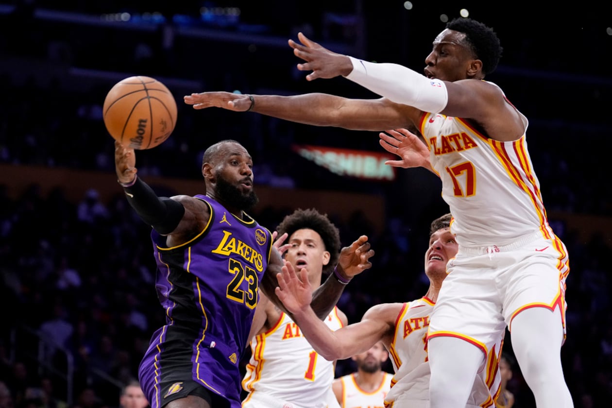 Los Angeles Lakers forward LeBron James, left, passes the ball as Atlanta Hawks forward Jalen Johnson, second from left, guard Bogdan Bogdanovic, second from right, and forward Onyeka Okongwu defend during the first half of an NBA basketball game, Friday, Jan. 3, 2025, in Los Angeles. (Mark J. Terrill/AP)