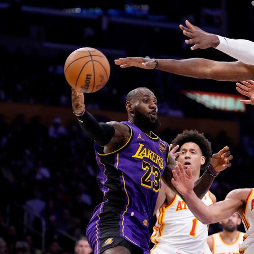 Los Angeles Lakers forward LeBron James, left, passes the ball as Atlanta Hawks forward Jalen Johnson, second from left, guard Bogdan Bogdanovic, second from right, and forward Onyeka Okongwu defend during the first half of an NBA basketball game, Friday, Jan. 3, 2025, in Los Angeles. (Mark J. Terrill/AP)