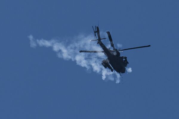 An Israeli Apache helicopter fires flares over the Gaza Strip as seen from southern Israel, Thursday, May 29, 2025. (AP Photo/Ohad Zwigenberg)