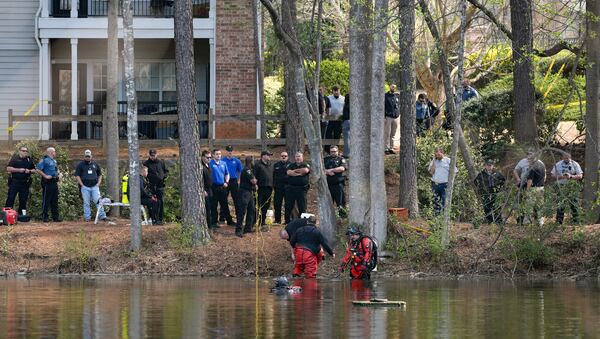 Police and fire department personnel from multiple agencies stand along a pond next to Sweetwater Road in Gwinnett County, where the body of 5-year-old Indi Bullock, who was autistic and nonverbal, was found on Friday, March 28, 2025. Bullock had been reported missing. (Ben Hendren for the Atlanta Journal-Constitution) 