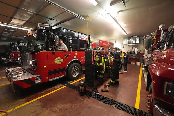 Waretown Volunteer Fire Company firefighters prepare to respond to a wildfire on Tuesday, April 22, 2025, in Waretown, N.J. (AP Photo/Chris Szagola)