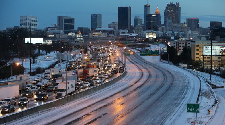 As dawn breaks early Wednesday morning January 29, 2014 South of Downtown Atlanta, the Connector Southbound is clogged with traffic as the Connector Northbound is an empty sheet of ice.
