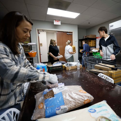 Volunteers from the Latin American Association organize boxes and bags of food in November to help the rising number of families who have lost incomes due to family members being detained by U.S. Immigration and Customs Enforcement. (Miguel Martinez/AJC 2025)