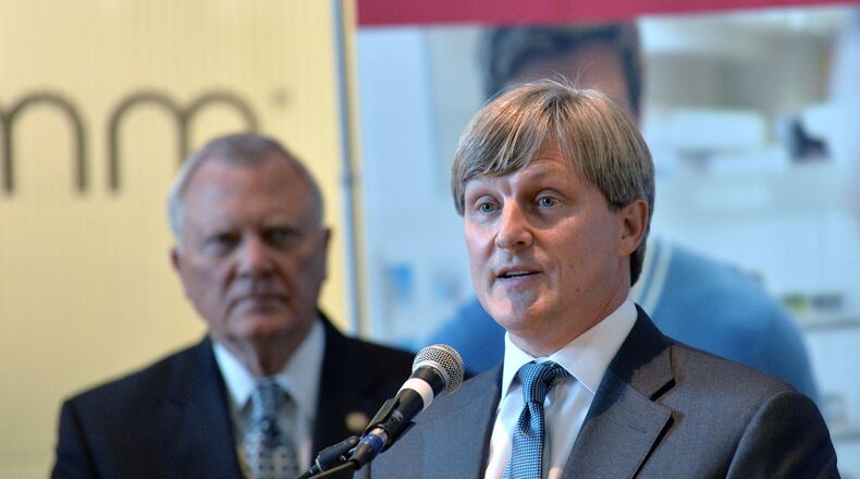 Scott Meyerhoff, Chief Operating Officer of InComm Inc., speaks as Gov. Nathan Deal looks during a press conference on Wed., Dec. 2, 2015. Georgia is renewing its efforts to recruit payment processors and other financial technology, or fintech, firms. InComm is participating in the University System of Georgia’s new Fintech Academy. HYOSUB SHIN / HSHIN@AJC.COM