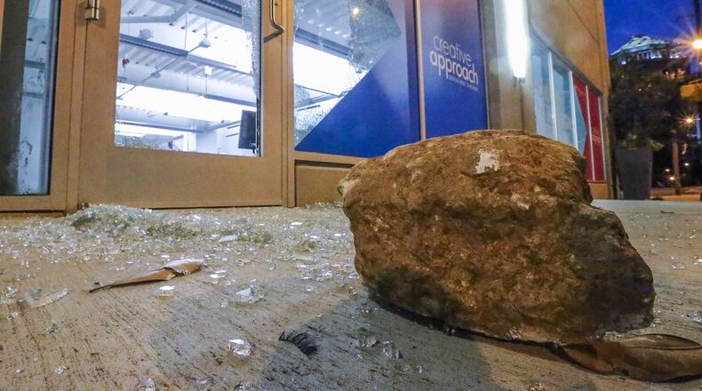 Burglars used a rock to smash through the front door of a Midtown printing shop early Thursday. JOHN SPINK / JSPINK@AJC.COM