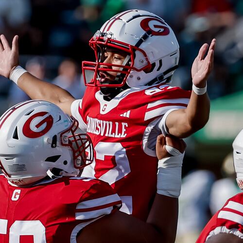Gainesville kicker Dwayne Carter III (right) celebrates his field goal with Ethan Aguirre during the first half against host Buford on Saturday, Aug. 22, 2026. Carter converted both of his field goal attempts in the 39-19 loss to the Wolves. (Erik S. Lesser for the AJC)