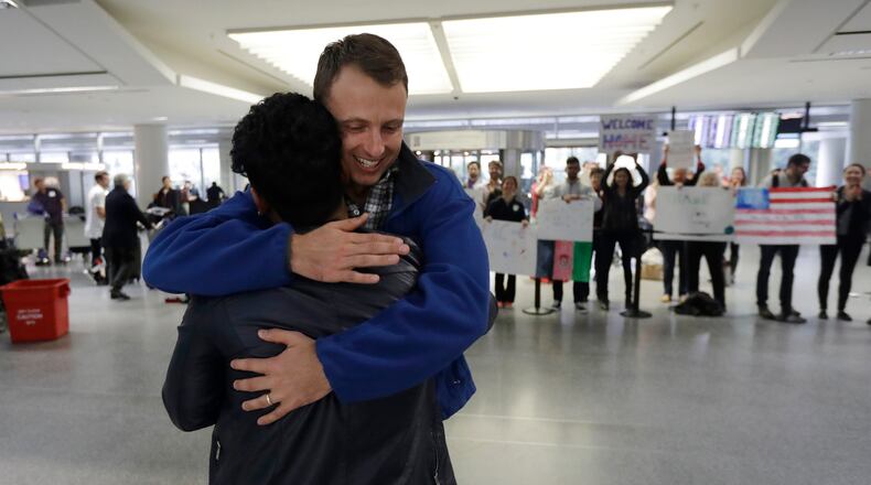 Army Capt. Matthew Ball, right, hugs his former interpreter Qismat Amin, as Amin arrives from Afghanistan, at San Francisco International Airport Wednesday, Feb. 8, 2017, in San Francisco. Ball welcomed Amin to the United States after buying him a plane ticket to ensure he would get in quickly amid concerns the Trump administration may expand its travel ban to Afghanistan. (AP Photo/Marcio Jose Sanchez)