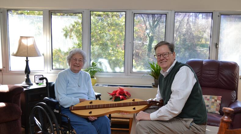 Betty Tarr, an independent living resident at Wesley Woods Towers, is shown here chatting with her son Sam about a handmade dulcimer that was a gift from her late husband. She didn’t wait for her children to have “the talk” with her about moving from her home in Hartwell. She knew it was no longer safe for her to live alone. CONTRIBUTED