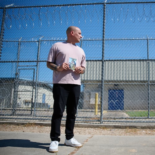 Army Staff Sgt. Alexis Jaramillo poses with a photo of his wife, Maisa Lopes Eliaser, a Brazilian national who is being detained by ICE, before visiting her at the South Louisiana ICE Processing Center in Basile, La., Sunday, Aug. 2, 2026. (AP Photo/Joseph Vidrine)