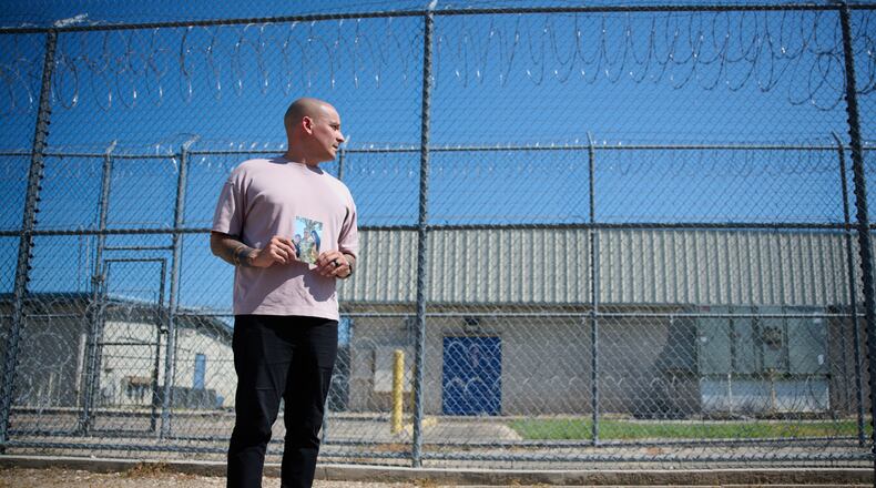 Army Staff Sgt. Alexis Jaramillo poses with a photo of his wife, Maisa Lopes Eliaser, a Brazilian national who is being detained by ICE, before visiting her at the South Louisiana ICE Processing Center in Basile, La., Sunday, Aug. 2, 2026. (AP Photo/Joseph Vidrine)