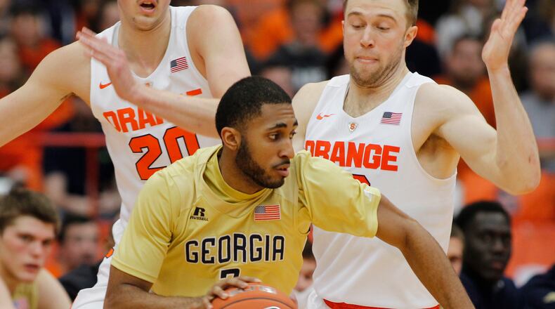 Georgia Techs Adam Smith, center, drives past Syracuses Tyler Lydon, left, and Trevor Cooney, right, during the second half of an NCAA college basketball game in Syracuse, N.Y., Saturday, Jan. 30, 2016. Syracuse won 60-57. (AP Photo/Nick Lisi)
