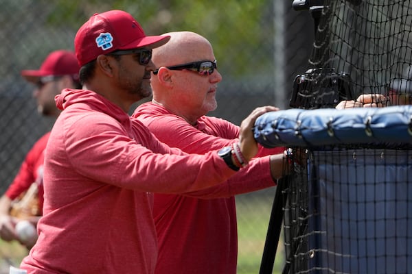 FILE - Washington Nationals manager Dave Martinez, left, watches with general manager Mike Rizzo during spring training baseball practice Saturday, Feb. 18, 2023, in West Palm Beach, Fla. Martinez, who played for the Braves in 2001, and Rizzo were fired Sunday. (AP Photo/Jeff Roberson, File)