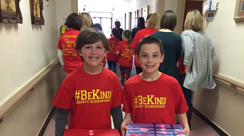 Liberty Elementary second graders Chase Walsh (left) and Brandon Holstein participate in a service project that delivered 100 boxes of Valentine wishes to residents of a senior center in Canton. The school was recently nationally recognized for its character education program.