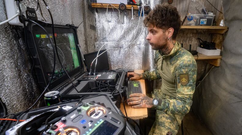 A Ukrainian serviceman of Khartia brigade controls an interceptor drone in the command centre Kharkiv region, Ukraine, Friday, June 26, 2026. (AP Photo/Andrii Marienko)