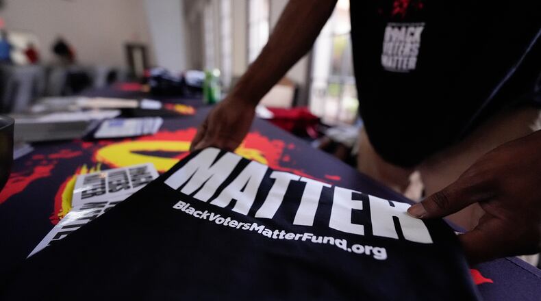 Nicholas Burns prepares his table at Bridgepointe Church during an event Wednesday, Sept. 16, 2026, in Marietta, Ga. (AP Photo/Mike Stewart)
