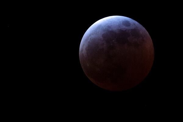 A total lunar eclipse enters its peak stage Thursday, March 13, 2025, in Portland, Ore. (AP Photo/Jenny Kane)