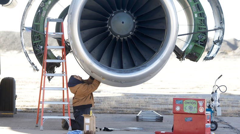 In this photo Tuesday, Dec. 10, 2013, photo, parts are removed from a retired American Airlines' jet engine in Roswell, New Mexico. (AP Photo/LM Otero)