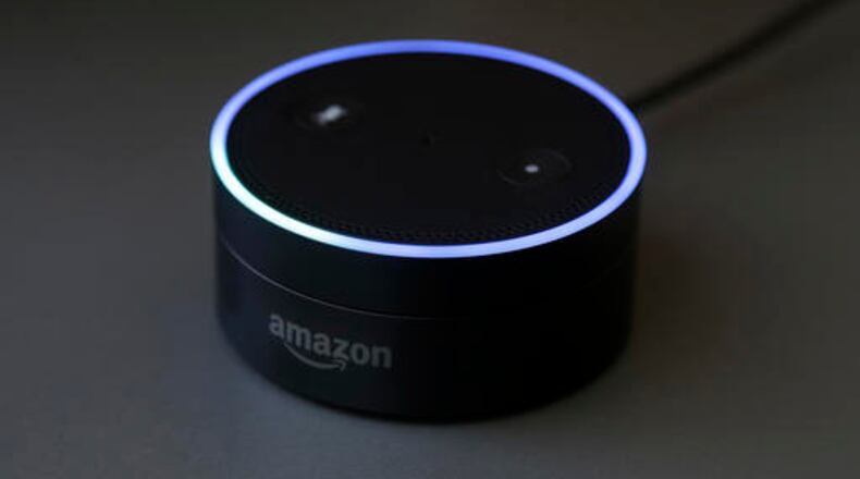 This Wednesday, March 2, 2016 photo shows an Echo Dot in San Francisco. Amazon.com is introducing two devices, the Amazon Tap and Echo Dot, that are designed to amplify the role that its voice-controlled assistant Alexa plays in people's homes and lives. (AP Photo/Jeff Chiu)