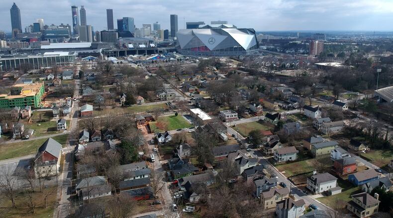 Aerial view of neighborhoods west of downtown Atlanta in the foreground and Mercedes-Benz Stadium in the background on Thursday, January 24, 2019. HYOSUB SHIN / HSHIN@AJC.COM