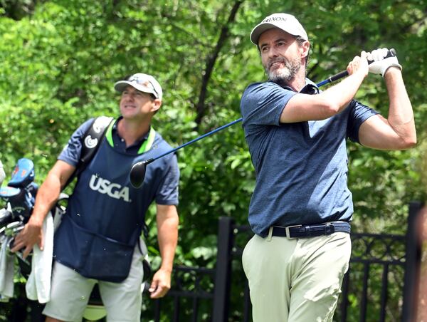 Mark Hensby, right, hits off of the tee on the 18th hole during the first session of the first day at the U.S. Senior Open Championship at Broadmoor Golf Club in Colorado Springs, Colo., Thursday, June 26, 2025. (Jerilee Bennett/The Gazette via AP)