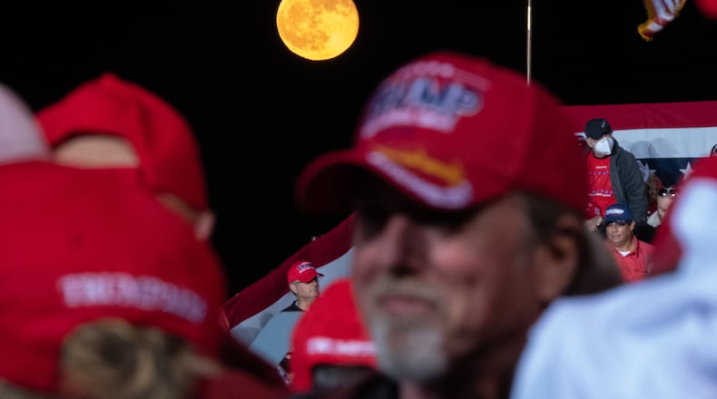 The moon rises behind supporters before the beginning of a President Donald Trump rally at Richard B. Russell Airport in Rome on Sunday evening, Nov. 1, 2020. A rally for his rival, Joe Biden, was canceled in Rome because Democrats said there was a threat from a militia presence. (Photo: Ben Gray for The Atlanta Journal-Constitution)